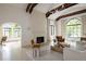 Bright living room featuring a fireplace, beamed ceilings, and large windows at 5800 E 6Th Avenue Pkwy, Denver, CO 80220