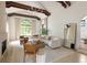 Bright living room with exposed beams, large windows, and modern furniture at 5800 E 6Th Avenue Pkwy, Denver, CO 80220