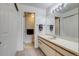 Bathroom with a long vanity, integrated sink, large mirror and a separate toilet room at 60 S Boulder # 6031, Boulder, CO 80303