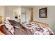 Bright bedroom featuring a cowhide-patterned bedspread and ensuite bathroom access at 60 S Boulder # 6031, Boulder, CO 80303