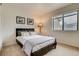Bedroom featuring a black headboard, neutral decor, and natural light from a window at 60 S Boulder # 6031, Boulder, CO 80303