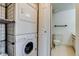 Laundry area with stackable washer and dryer located next to the half bath at 60 S Boulder # 6031, Boulder, CO 80303