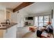 Living room featuring fireplace, balcony access, and view into the kitchen area at 60 S Boulder # 6031, Boulder, CO 80303