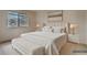 Bright main bedroom featuring a large window, bench, and staged decor at 60 S Boulder # 6031, Boulder, CO 80303