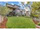 Spacious backyard featuring lush green lawn, mature landscaping, and elegant exterior design at 481 Meadowleaf Ln, Highlands Ranch, CO 80126