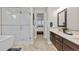 A spa-like bathroom features a glass enclosed shower, vanity, and a soaking tub at 481 Meadowleaf Ln, Highlands Ranch, CO 80126