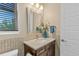 Neutral powder bathroom with a vanity and decorative mirror at 481 Meadowleaf Ln, Highlands Ranch, CO 80126