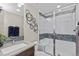 Modern bathroom features a glass-enclosed shower with decorative tile and a sleek vanity at 481 Meadowleaf Ln, Highlands Ranch, CO 80126