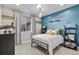 Well-lit bedroom with airplane wall art, comfortable bed, decorative shelves, and a large window at 481 Meadowleaf Ln, Highlands Ranch, CO 80126