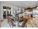 Elegant dining area with modern table and chairs, adjacent to a bright kitchen space at 481 Meadowleaf Ln, Highlands Ranch, CO 80126