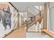 Bright, airy foyer featuring a modern staircase, unique artwork, hardwood floors, and lots of natural light at 481 Meadowleaf Ln, Highlands Ranch, CO 80126