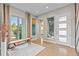 Welcoming entryway with a large window, bench, and a view of the staircase, highlighting the home's bright and modern design at 481 Meadowleaf Ln, Highlands Ranch, CO 80126