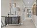 Hallway featuring decorative cabinet, stylish lamp, and inviting decor with access to other rooms at 481 Meadowleaf Ln, Highlands Ranch, CO 80126