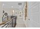 Well-lit hallway features modern railing, neutral walls, and decorative wall art at 481 Meadowleaf Ln, Highlands Ranch, CO 80126