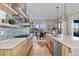 Contemporary kitchen featuring light wood cabinets, quartz countertops, and stainless steel appliances at 481 Meadowleaf Ln, Highlands Ranch, CO 80126