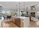 Spacious kitchen featuring a large island, modern appliances, and open access to the dining and living areas at 481 Meadowleaf Ln, Highlands Ranch, CO 80126
