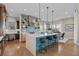 Stylish kitchen island with barstool seating, modern lighting, and decorative accents at 481 Meadowleaf Ln, Highlands Ranch, CO 80126