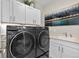 Practical laundry room featuring a modern washer and dryer and ample storage cabinets at 481 Meadowleaf Ln, Highlands Ranch, CO 80126