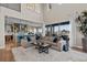 Open-concept living area with a large sofa, modern decor, and seamless flow into the kitchen and outdoor spaces at 481 Meadowleaf Ln, Highlands Ranch, CO 80126