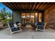 Cozy covered patio with comfortable seating area and stylish outdoor decor at 481 Meadowleaf Ln, Highlands Ranch, CO 80126