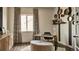 Contemporary home office with modern desk, stylish accents, and plush ottoman at 16500 Black Rose Cir, Parker, CO 80134