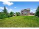Expansive backyard featuring a lush green lawn and mature trees at 35 N Newcastle Ct, Aurora, CO 80018