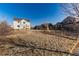 Large backyard with grassy area, fenced in garden, and other houses in the distance at 35 N Newcastle Ct, Aurora, CO 80018