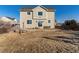 Back of house with patio and grassy area at 35 N Newcastle Ct, Aurora, CO 80018
