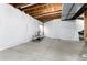 Unfinished basement area featuring concrete floors and white privacy curtains at 35 N Newcastle Ct, Aurora, CO 80018