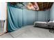 Finished basement area featuring a bed and blue privacy curtains at 35 N Newcastle Ct, Aurora, CO 80018