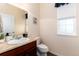 A half bathroom with updated vanity, fixtures, and finishes at 35 N Newcastle Ct, Aurora, CO 80018