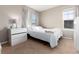 A minimalist bedroom featuring neutral tones and natural light through large windows at 35 N Newcastle Ct, Aurora, CO 80018