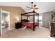 Spacious bedroom with four-poster bed, vaulted ceiling, and attached bath with shower at 35 N Newcastle Ct, Aurora, CO 80018