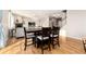 A dining area with dark wood furniture and seating for four, adjacent to the living area at 35 N Newcastle Ct, Aurora, CO 80018
