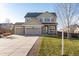 Charming two-story home featuring a three-car garage, inviting front porch, and manicured lawn in a Gathering-friendly neighborhood at 35 N Newcastle Ct, Aurora, CO 80018