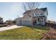Charming two-story home featuring a three-car garage, inviting front porch, and manicured lawn in a Gathering-friendly neighborhood at 35 N Newcastle Ct, Aurora, CO 80018