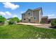 Exterior elevation of the back of the home with a patio and grassy yard at 35 N Newcastle Ct, Aurora, CO 80018