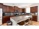 Kitchen features an island with granite countertop, stainless steel appliances, and brown cabinets at 35 N Newcastle Ct, Aurora, CO 80018