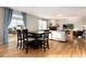 Open-concept living room with hardwood floors, a fireplace, and large windows for natural light at 35 N Newcastle Ct, Aurora, CO 80018