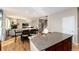 View from kitchen showing open concept living area with fireplace and dining area at 35 N Newcastle Ct, Aurora, CO 80018
