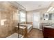 A well-lit bathroom featuring a glass shower, soaking tub, and double vanity at 35 N Newcastle Ct, Aurora, CO 80018