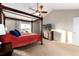 Spacious main bedroom with a four-poster bed, TV, and neutral décor at 35 N Newcastle Ct, Aurora, CO 80018