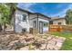 Backyard stone patio area with white siding on the house and black trim at 1012 Fillmore St, Denver, CO 80206