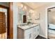 Bathroom featuring double granite vanity, dark wood floors, and view to the bedroom at 1012 Fillmore St, Denver, CO 80206