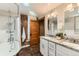 Bathroom boasts brick accent wall, soaking tub, and a double sink vanity with granite countertops at 1012 Fillmore St, Denver, CO 80206