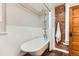 Bathroom showcases a clawfoot tub with exposed plumbing and a brick accent wall at 1012 Fillmore St, Denver, CO 80206