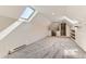 Bright bedroom featuring a skylight, neutral walls and gray carpeting at 1012 Fillmore St, Denver, CO 80206