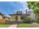 Charming home with a well-maintained yard, red stone pathway, and inviting covered porch at 1012 Fillmore St, Denver, CO 80206