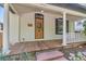 Inviting front porch featuring a wooden deck, brick wall, and charming white columns at 1012 Fillmore St, Denver, CO 80206