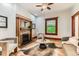Cozy living room featuring a brick fireplace, hardwood floors, and natural light at 1012 Fillmore St, Denver, CO 80206